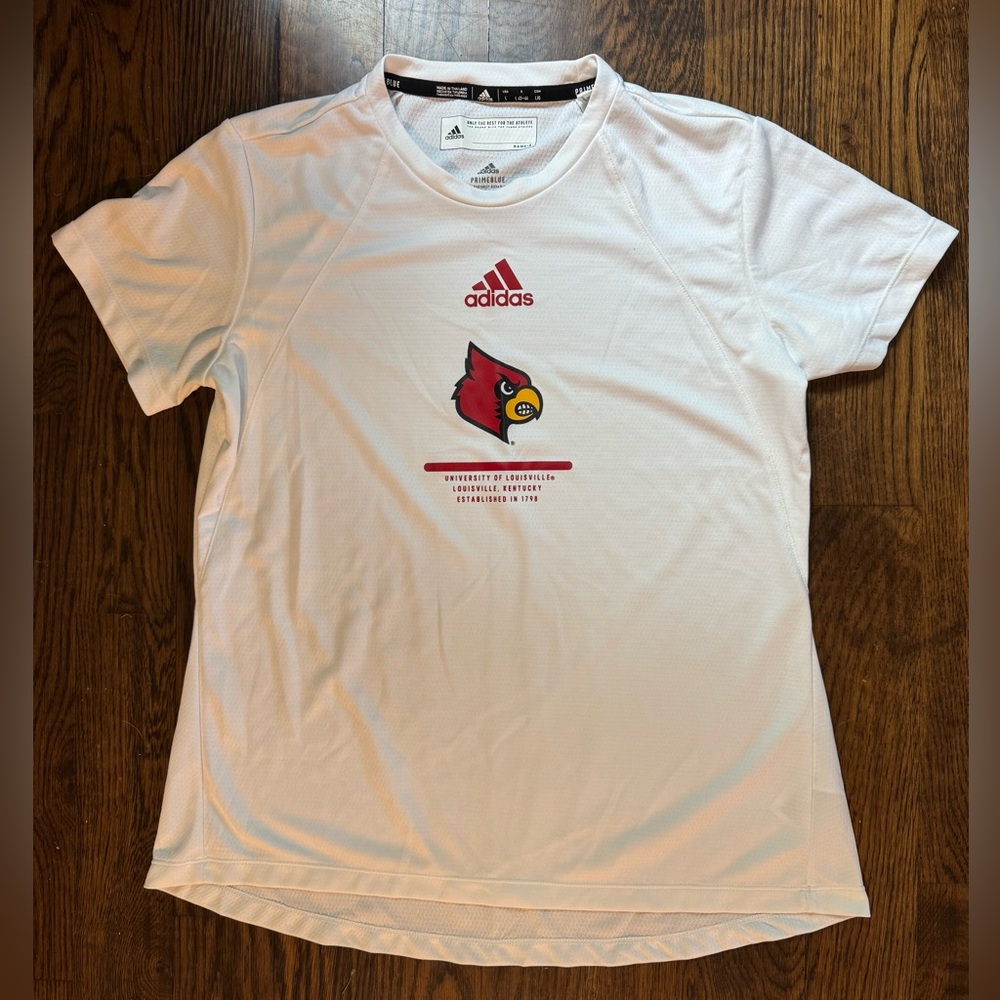 UofL Adidas PRIMEBLUE White women’s cut Shirt with University of Louisville logo